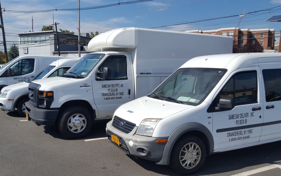 Mixed fleet of cargo vans and box truck at the yard